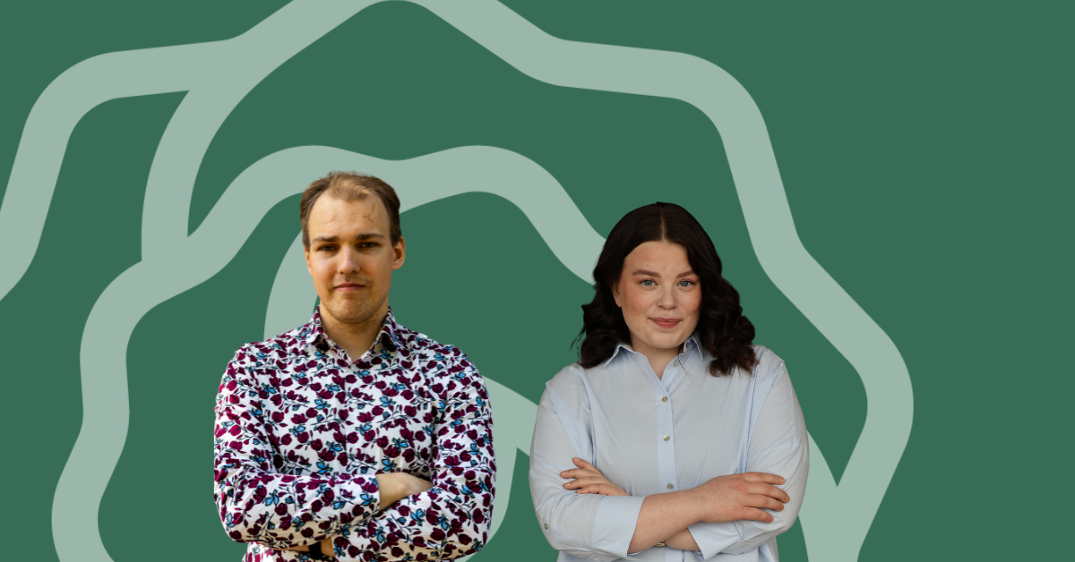 nainen ja mies kädet puuskassa vihreää taustaa vasten.